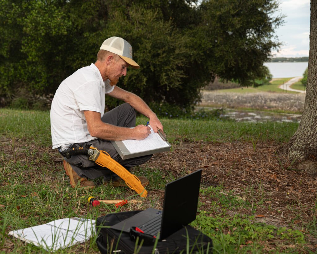 Certified Arborist documenting tree conditions during an on-site assessment